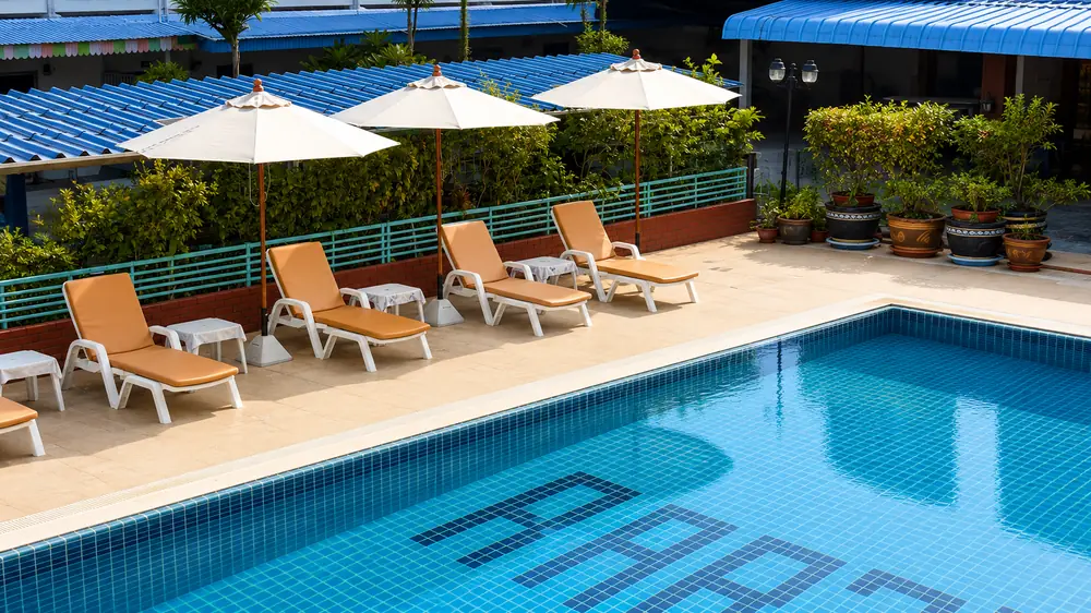 Outdoor pool with loungers and parasols