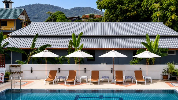 Outdoor pool with loungers and the hills behind